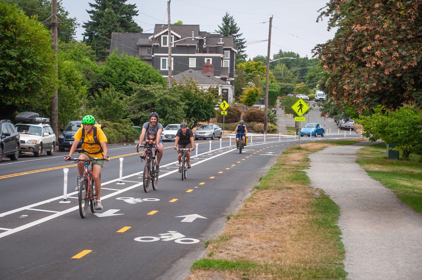 Photo of people riding their bicycles on the two-way Green Lake protected bike lane. Photo: Seattle Department of Transportation